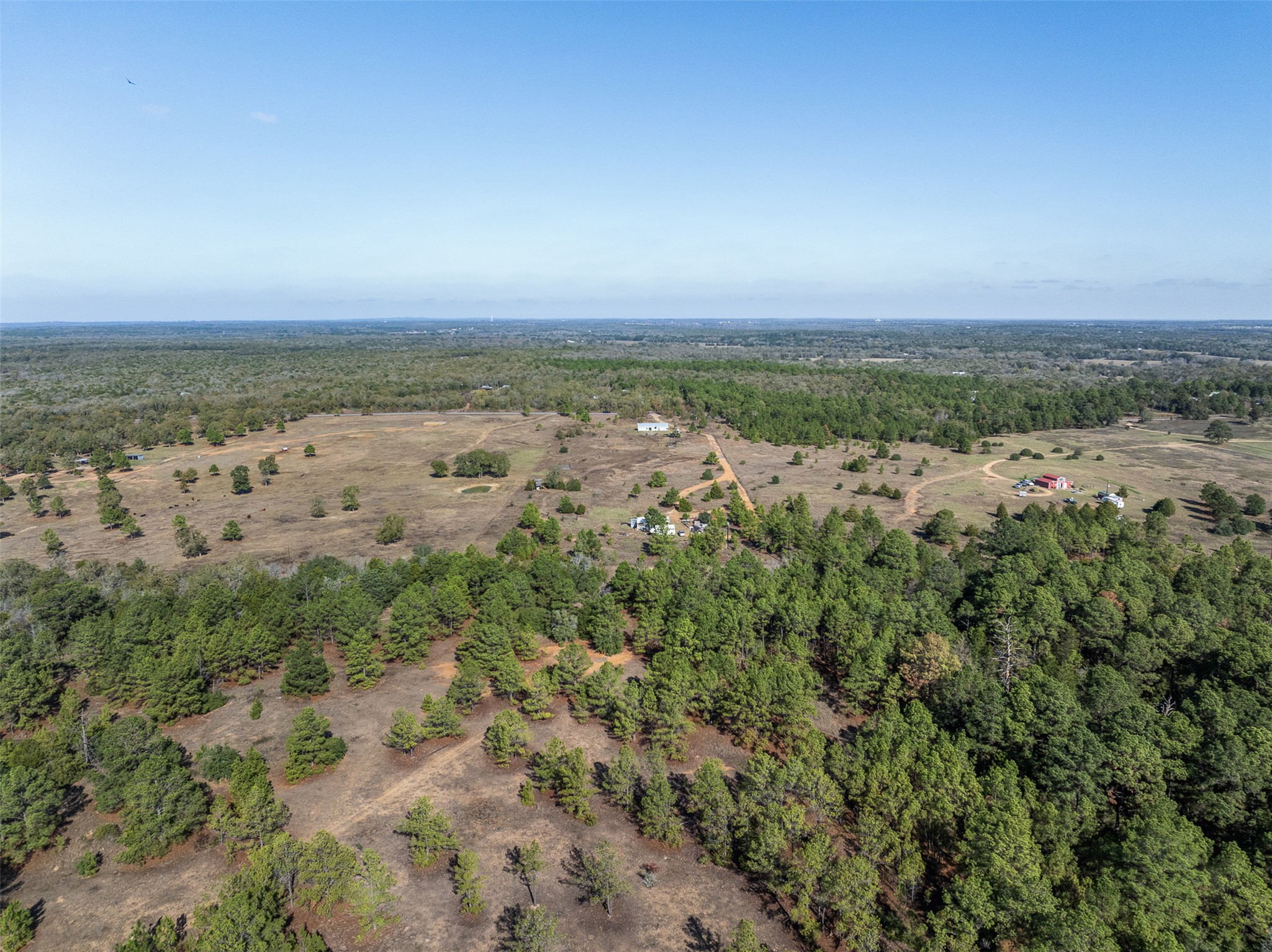 1759 Gotier Trace Road Paige, TX 78659 - Photo 37 of 40 an aerial view of a city with lots of residential buildings and mountain view in back