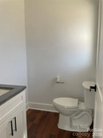 a white toilet sitting next to a white sink