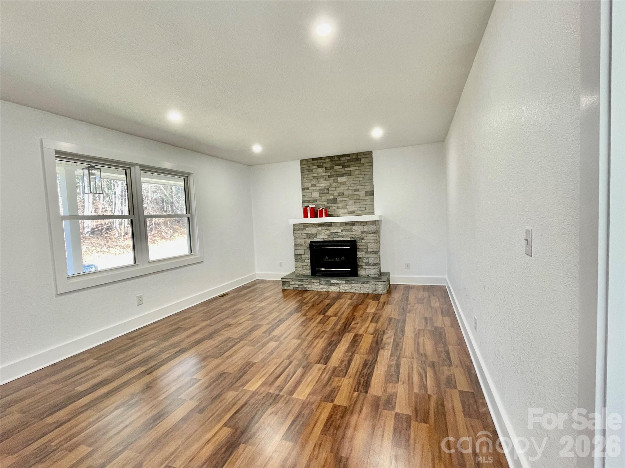 2019 Dale Road Spruce Pine, NC 28777 - Photo 6 of 18 a view of empty room with wooden floor and fireplace