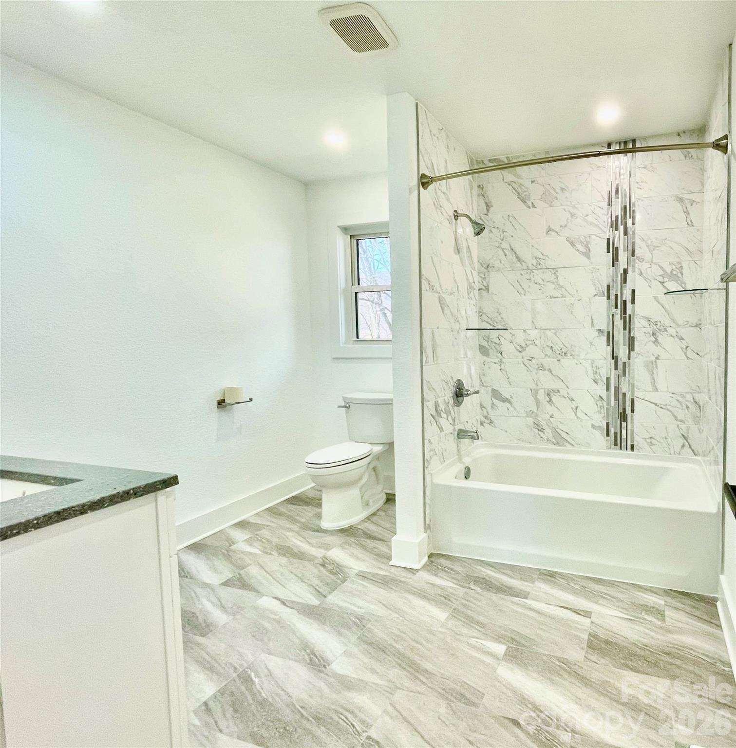 2019 Dale Road Spruce Pine, NC 28777 - Photo 10 of 18 a bathroom with a bathtub shower sink and toilet