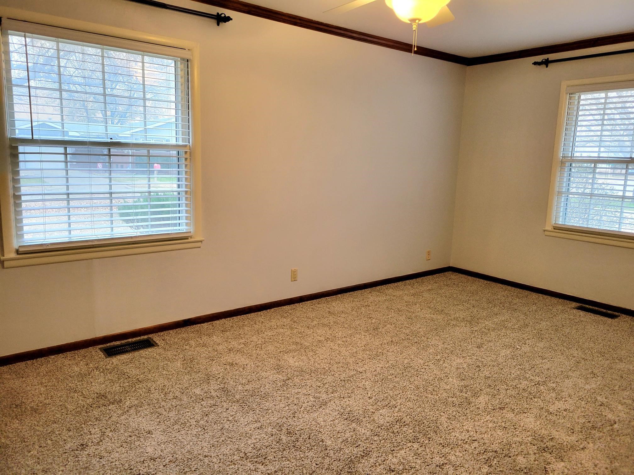 135 Redbud Drive Winfield, KS 67156 - Photo 14 of 29 This nice sized bedroom has fresh paint, brand new carpet, it's own master bath AND a walk in closet
