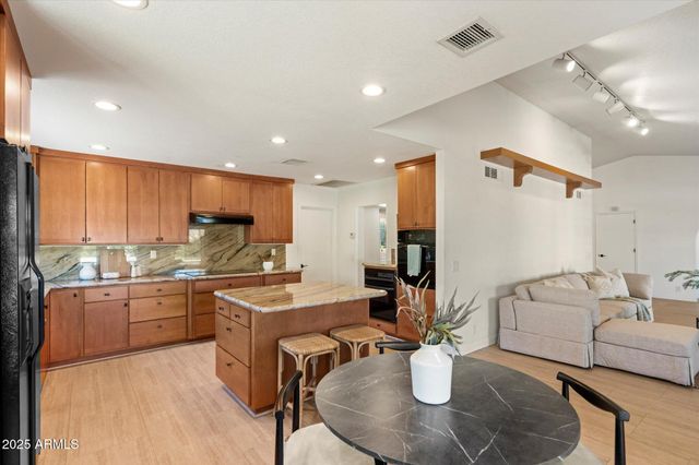 a kitchen with stainless steel appliances granite countertop a sink and cabinets