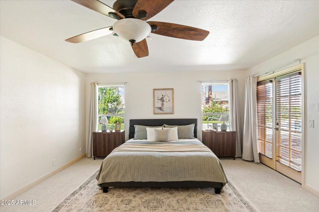 a bedroom with a large bed and a large window