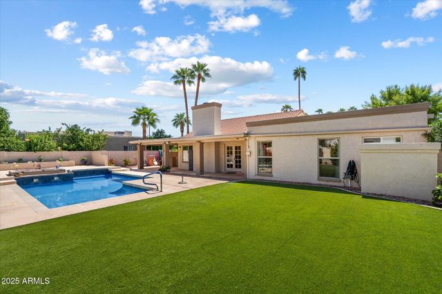 a view of a house with pool and chairs