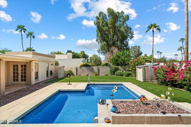 a view of a house with swimming pool yard and patio