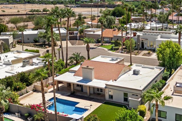 an aerial view of a house with a yard patio and outdoor seating