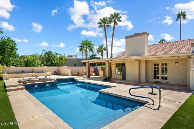 a living room with furniture pool table and chairs