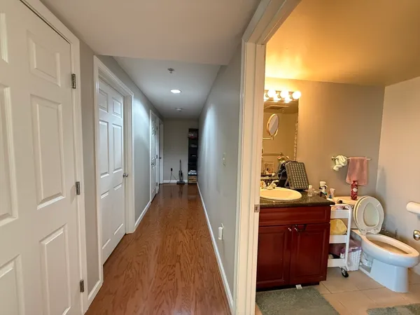 a bathroom with a sink a toilet and a mirror
