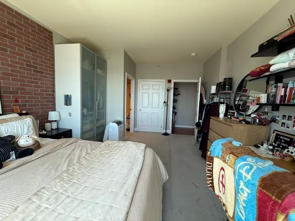 a bedroom with bed and a window