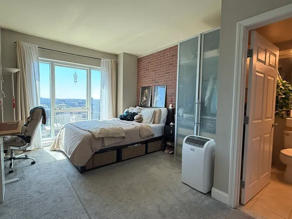 a bedroom with a bed and a chair