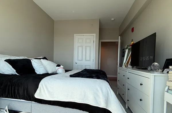 a bedroom with a bed and a flat screen tv
