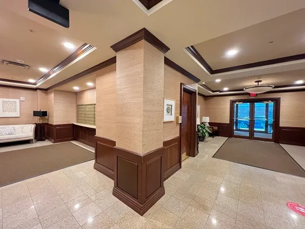 a large room with lots of furniture and a chandelier