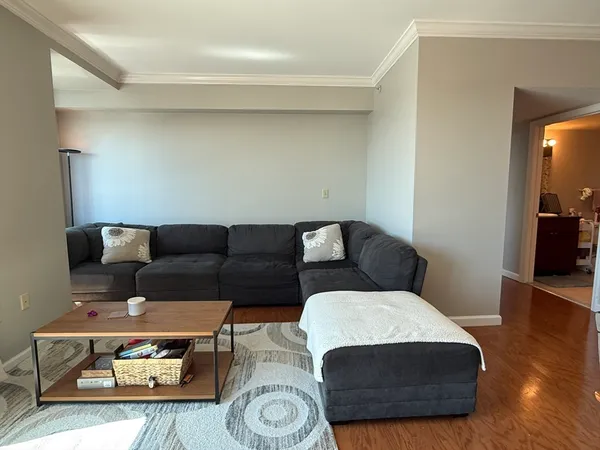 a living room with furniture and wooden floor