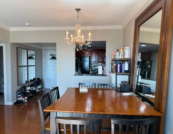 a room with furniture and view of kitchen