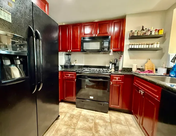 a kitchen with stainless steel appliances granite countertop a stove a refrigerator and a sink