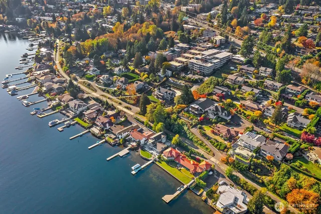 an aerial view of residential houses with outdoor space and parking