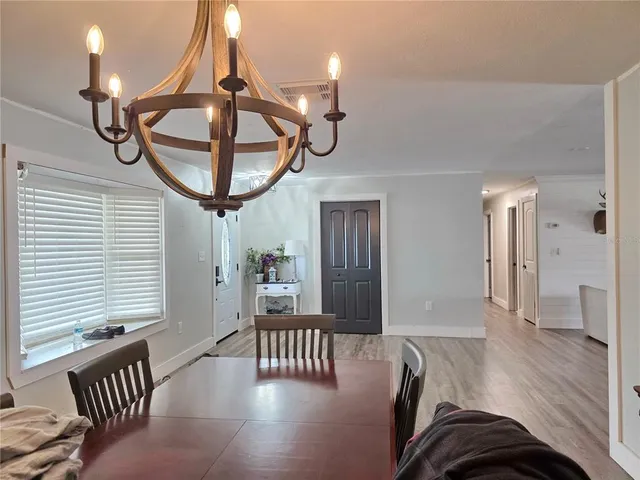a view of entryway livingroom and hall with wooden floor