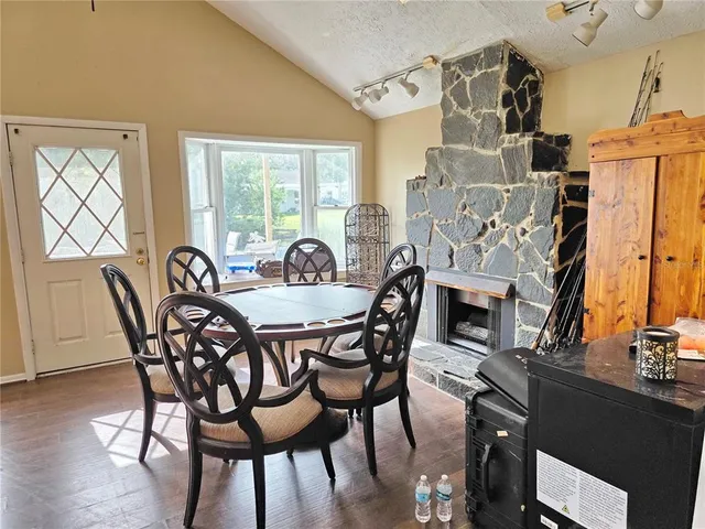 a dining room with furniture window and wooden floor
