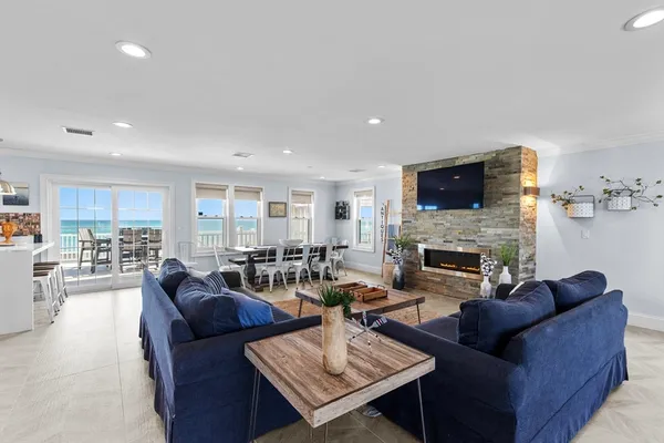 a living room with furniture a fireplace and a flat screen tv