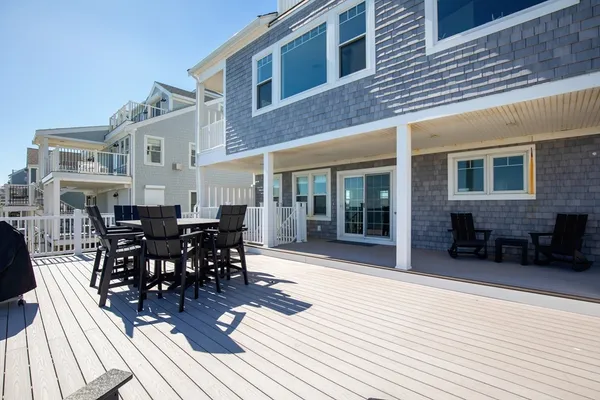 a view of a patio with table and chairs and floor to ceiling window