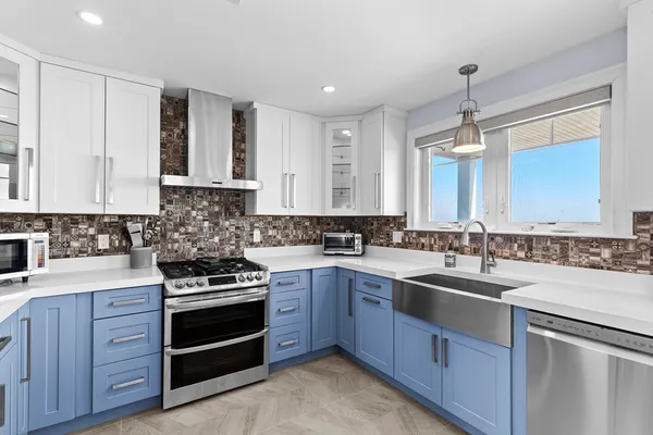 a kitchen with a sink stove and cabinets