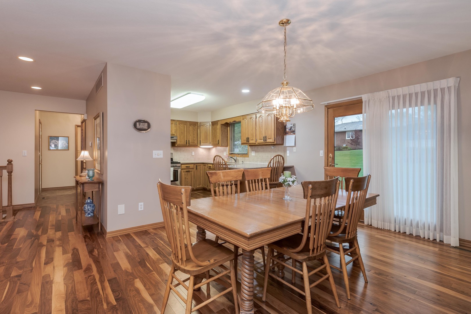 103 East 9th Street Gridley, IL 61744 - Photo 11 of 45 a view of a dining room and livingroom with furniture wooden floor a chandelier