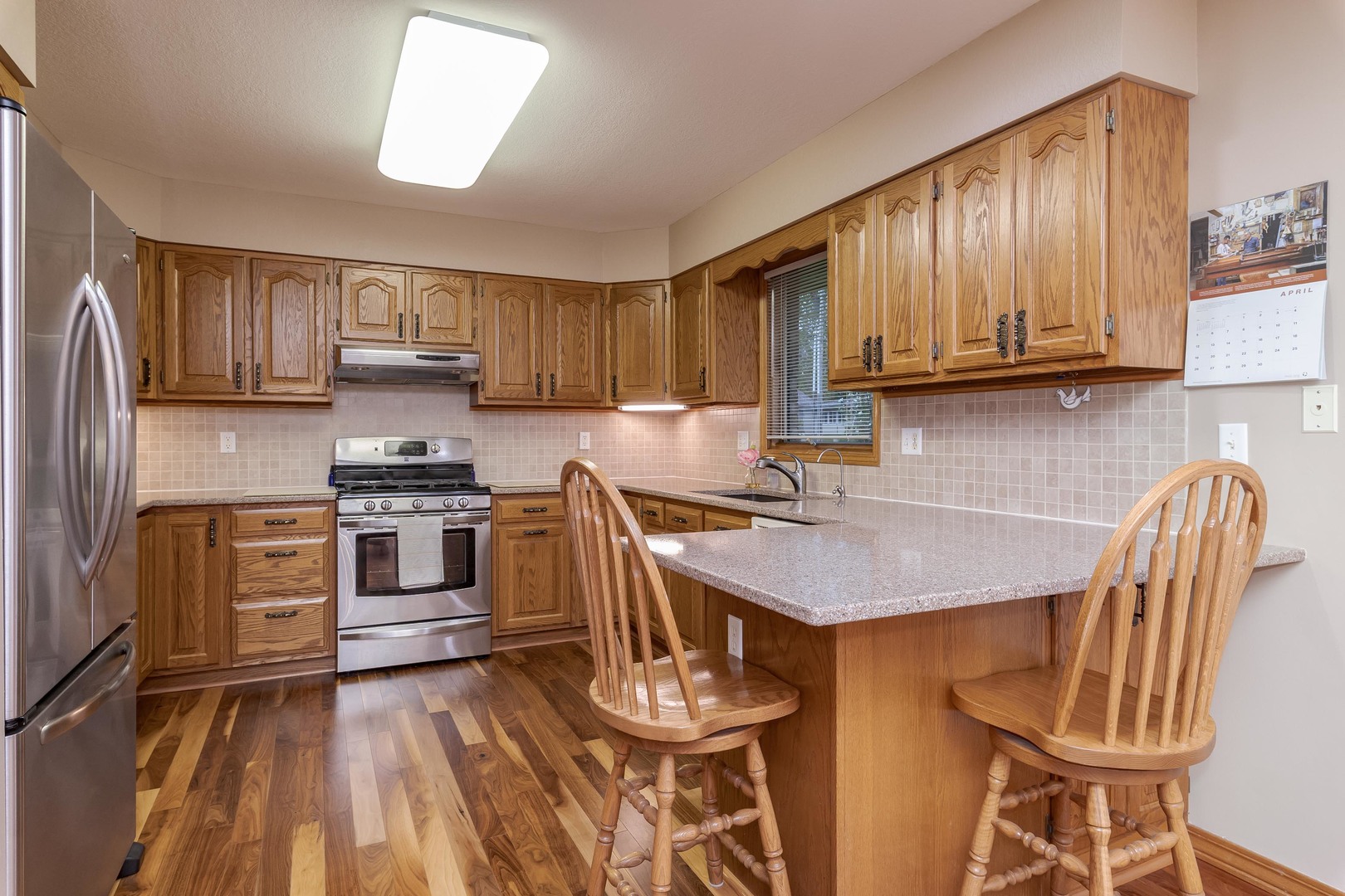 103 East 9th Street Gridley, IL 61744 - Photo 14 of 45 a kitchen with stainless steel appliances a stove a sink a microwave a refrigerator and cabinets