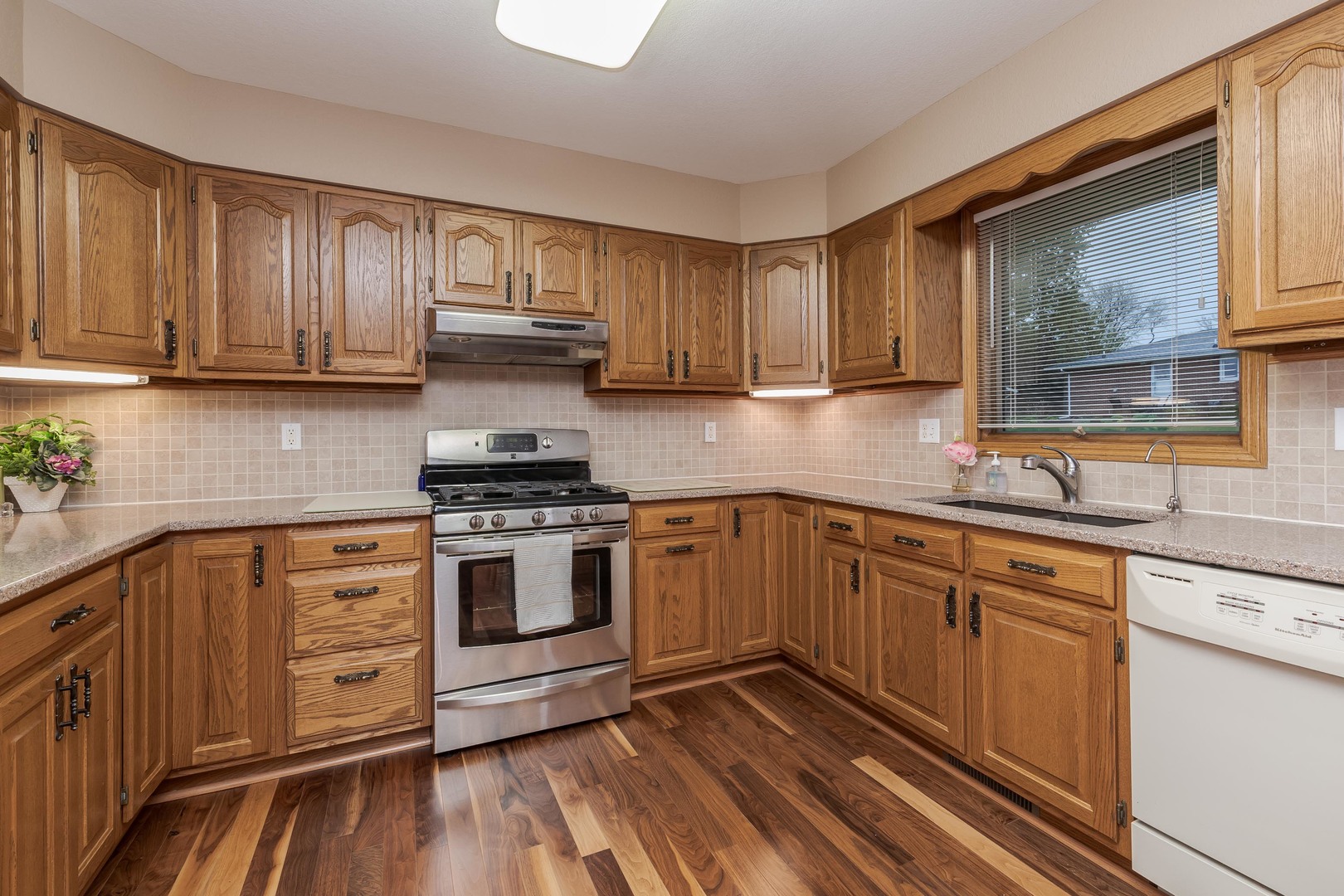 103 East 9th Street Gridley, IL 61744 - Photo 15 of 45 a kitchen with granite countertop wooden cabinets and a stove