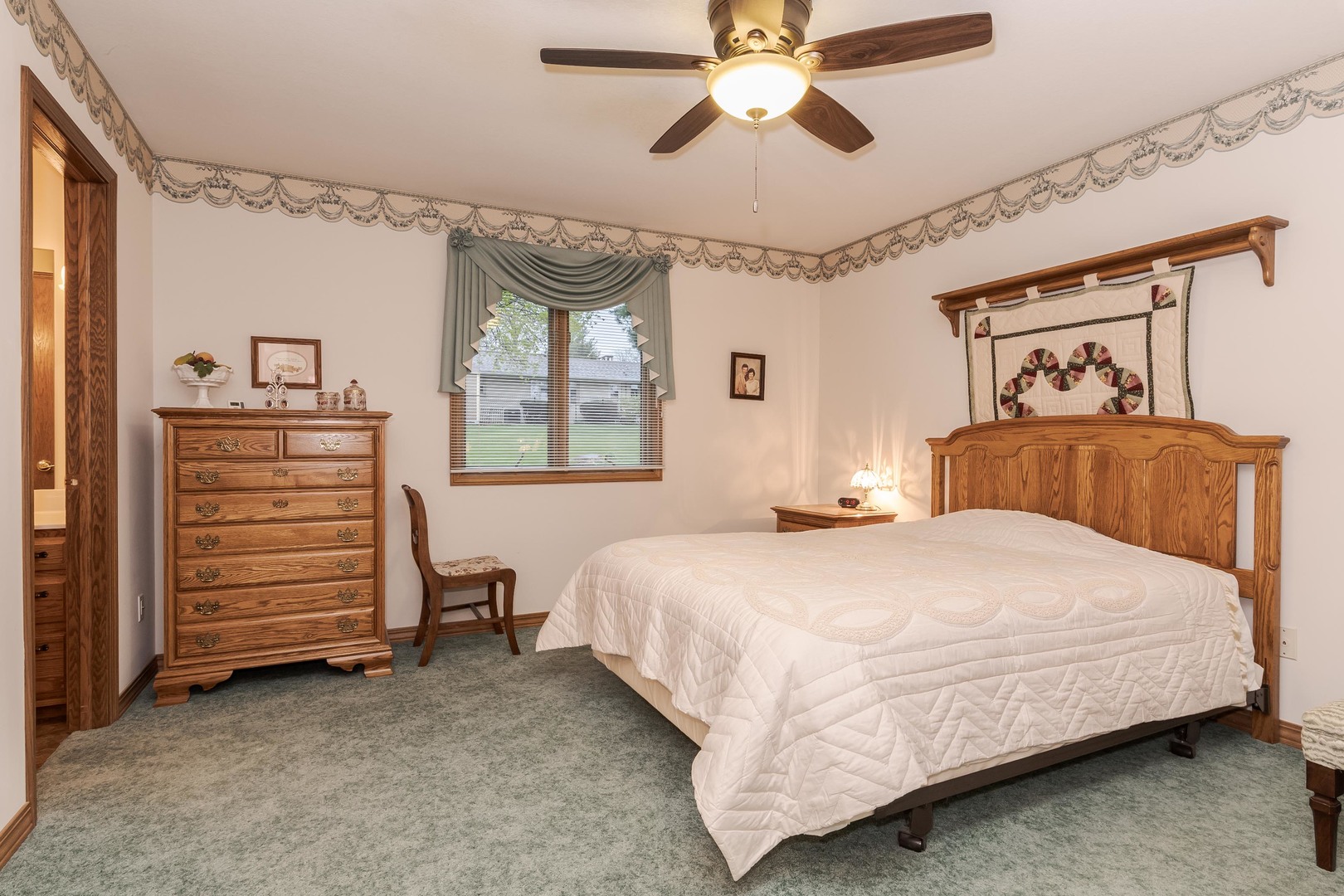 103 East 9th Street Gridley, IL 61744 - Photo 17 of 45 a bedroom with a bed and a chandelier