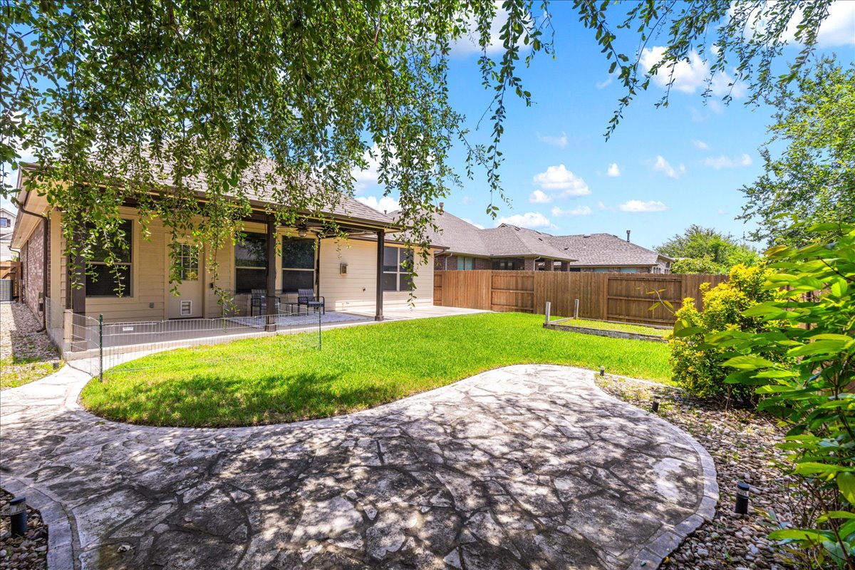 137 Navigator Drive Austin, TX 78717 - Photo 17 of 18 a view of a backyard with a garden and plants