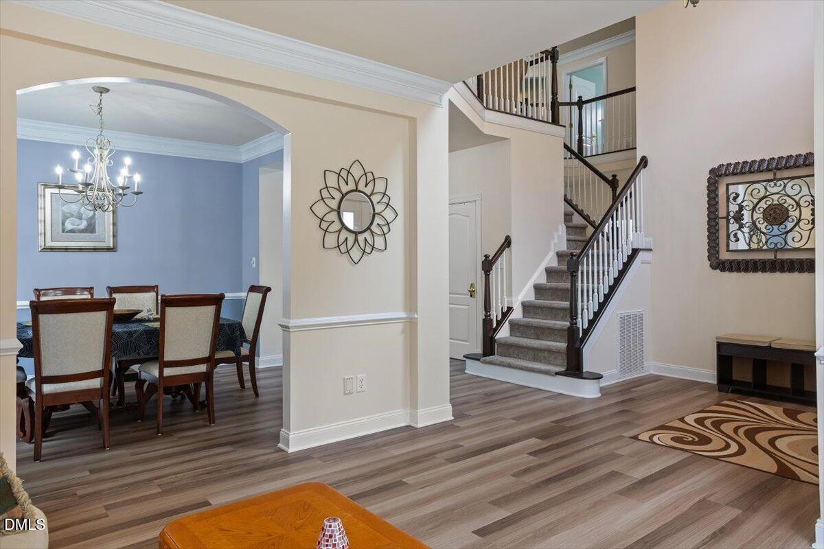 9208 Palm Bay Circle Raleigh, NC 27617 - Photo 10 of 54 a view of a dining room with furniture wooden floor and a chandelier