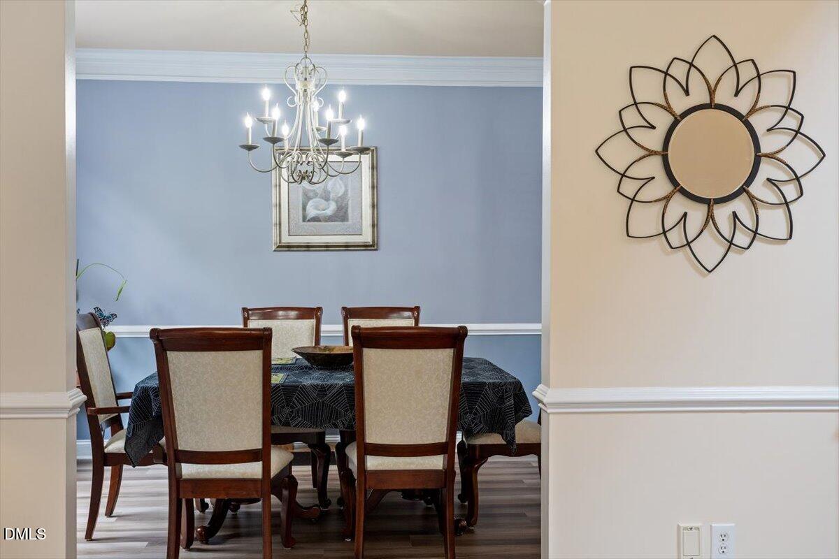 9208 Palm Bay Circle Raleigh, NC 27617 - Photo 11 of 54 a view of a dining room with furniture and wooden floor