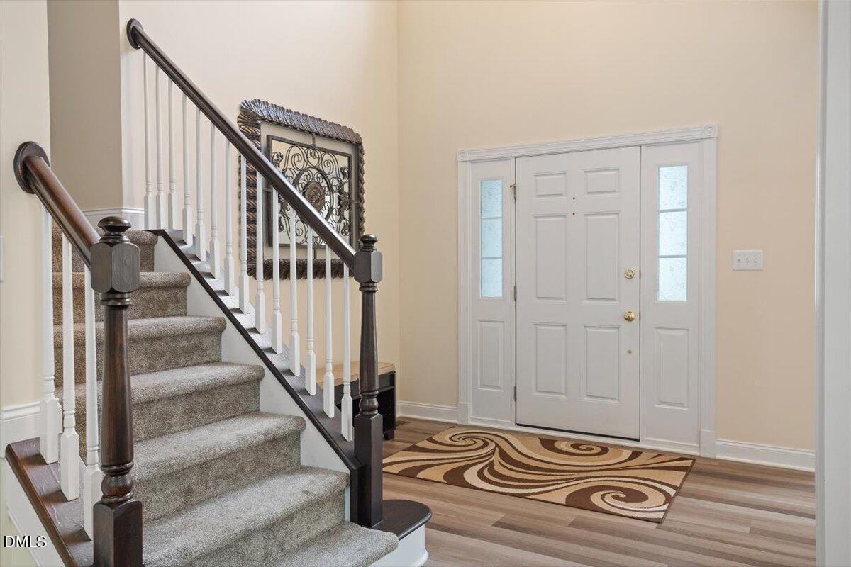 9208 Palm Bay Circle Raleigh, NC 27617 - Photo 15 of 54 a view of a hallway with wooden floor and staircase