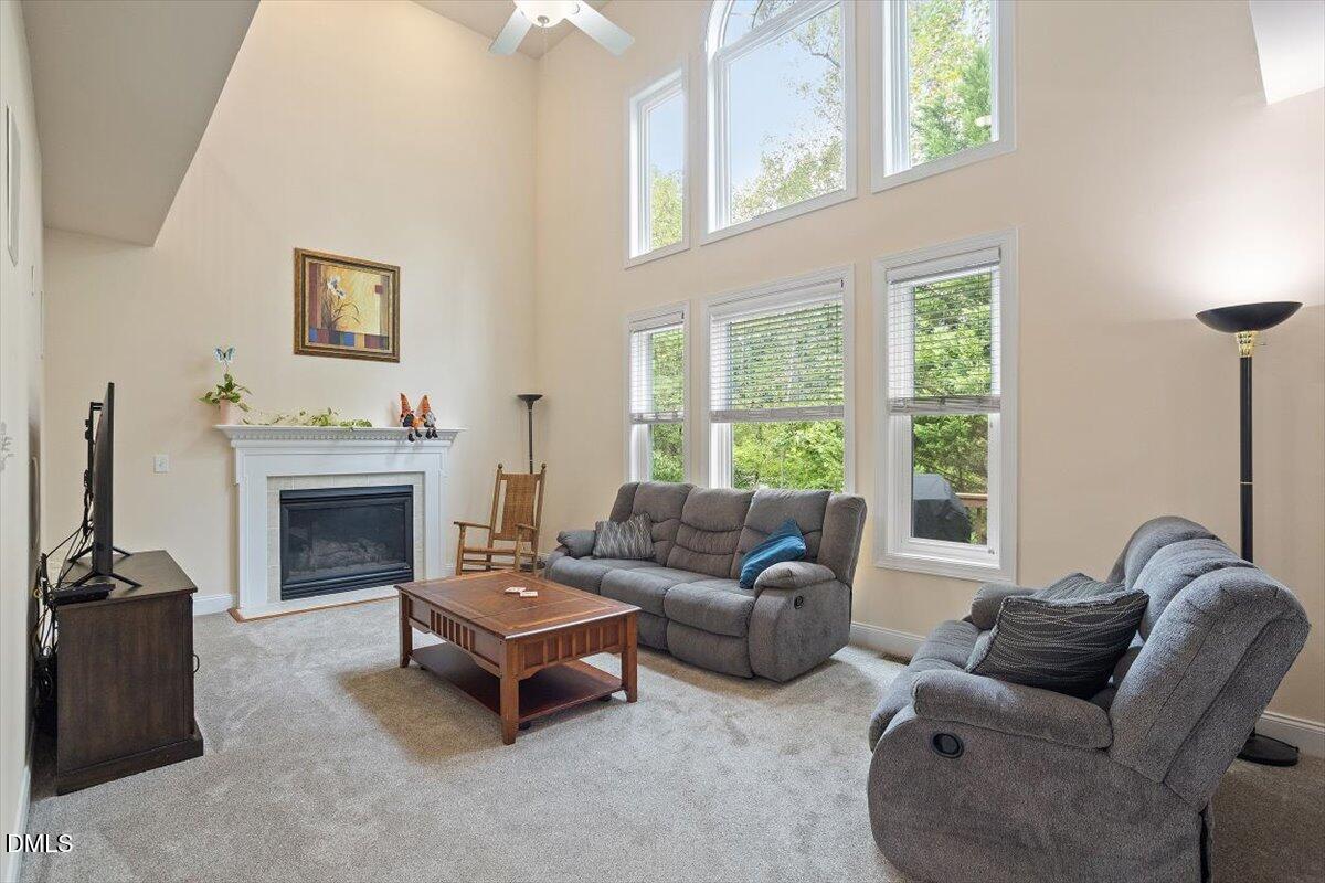 9208 Palm Bay Circle Raleigh, NC 27617 - Photo 16 of 54 a living room with furniture a window and a fireplace