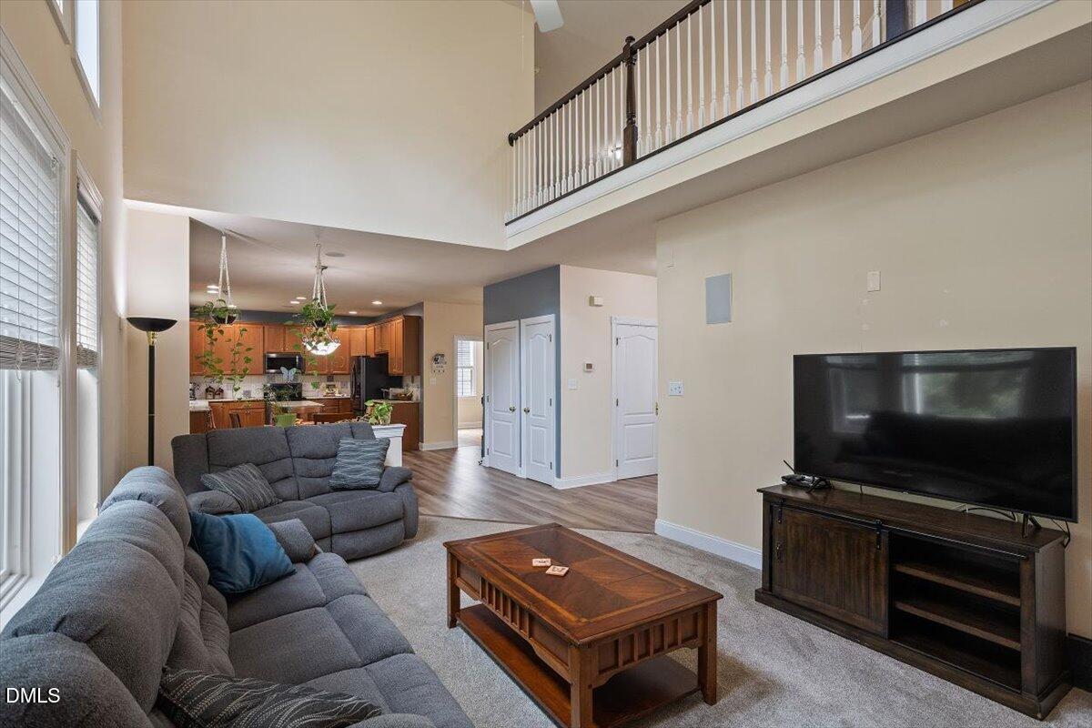 9208 Palm Bay Circle Raleigh, NC 27617 - Photo 17 of 54 a living room with furniture and a flat screen tv
