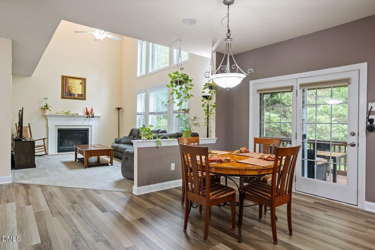 9208 Palm Bay Circle Raleigh, NC 27617 - Photo 19 of 54 a dining room with furniture window fireplace and wooden floor