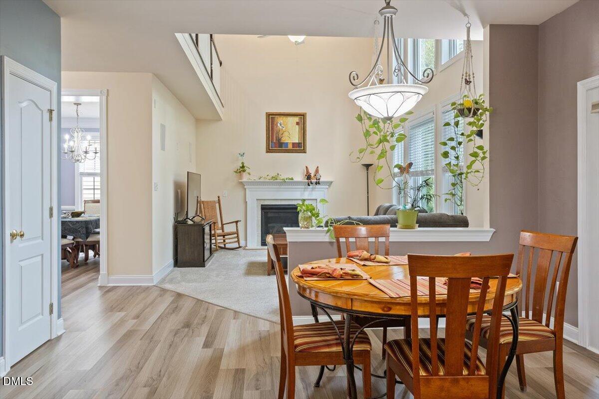 9208 Palm Bay Circle Raleigh, NC 27617 - Photo 20 of 54 a view of a dining room with furniture wooden floor and chandelier