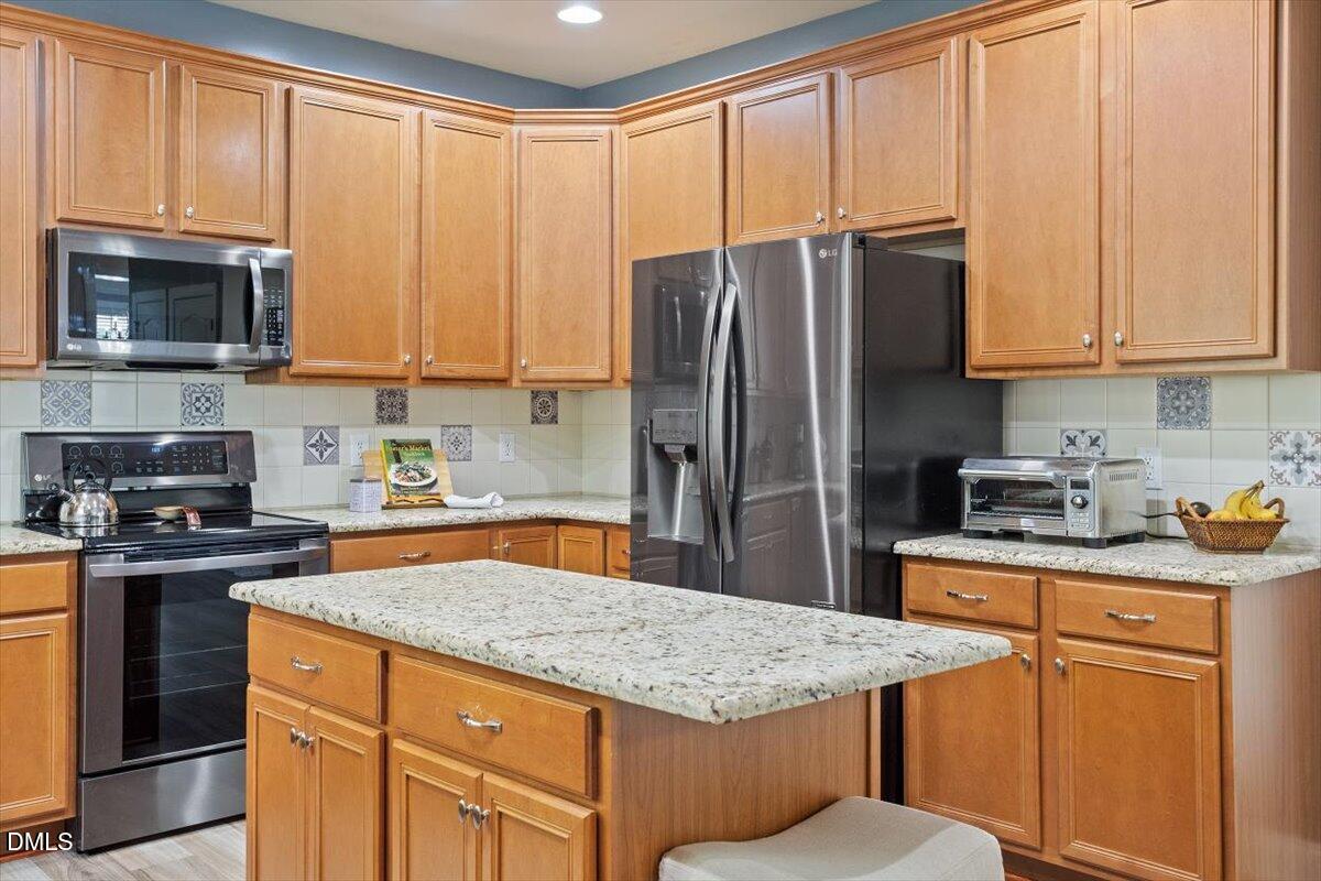 9208 Palm Bay Circle Raleigh, NC 27617 - Photo 24 of 54 a kitchen with stainless steel appliances granite countertop a stove a sink dishwasher and a refrigerator