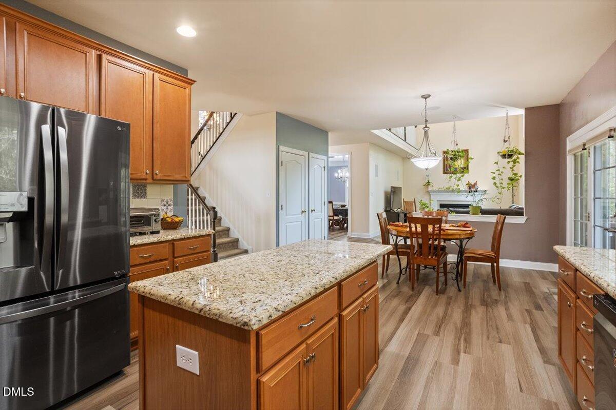 9208 Palm Bay Circle Raleigh, NC 27617 - Photo 25 of 54 a kitchen with stainless steel appliances granite countertop table chairs and a refrigerator