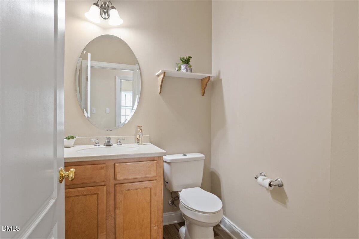 9208 Palm Bay Circle Raleigh, NC 27617 - Photo 30 of 54 a bathroom with a toilet sink and mirror