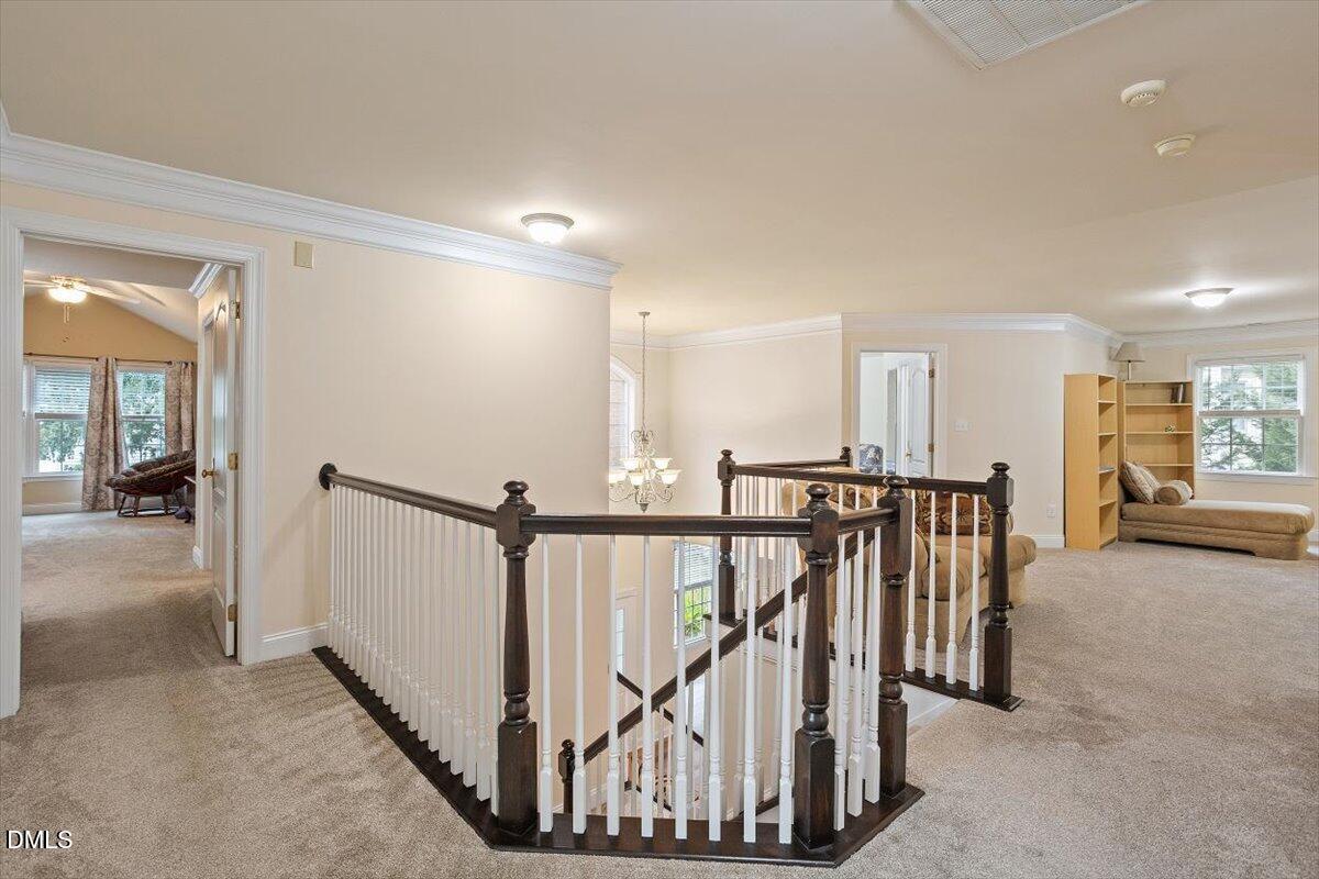 9208 Palm Bay Circle Raleigh, NC 27617 - Photo 32 of 54 a view of a hallway with wooden floor and stairs