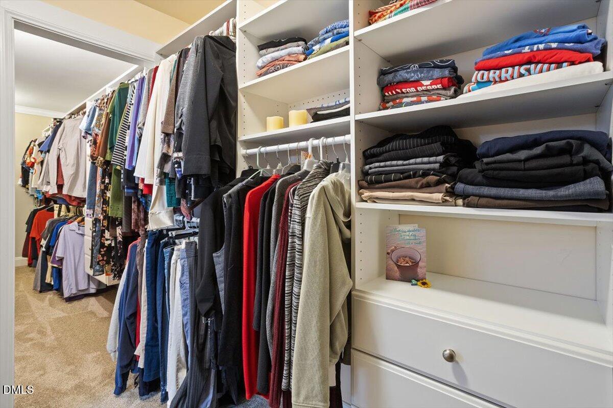 9208 Palm Bay Circle Raleigh, NC 27617 - Photo 38 of 54 a view of walk in closet with clothes and shoes