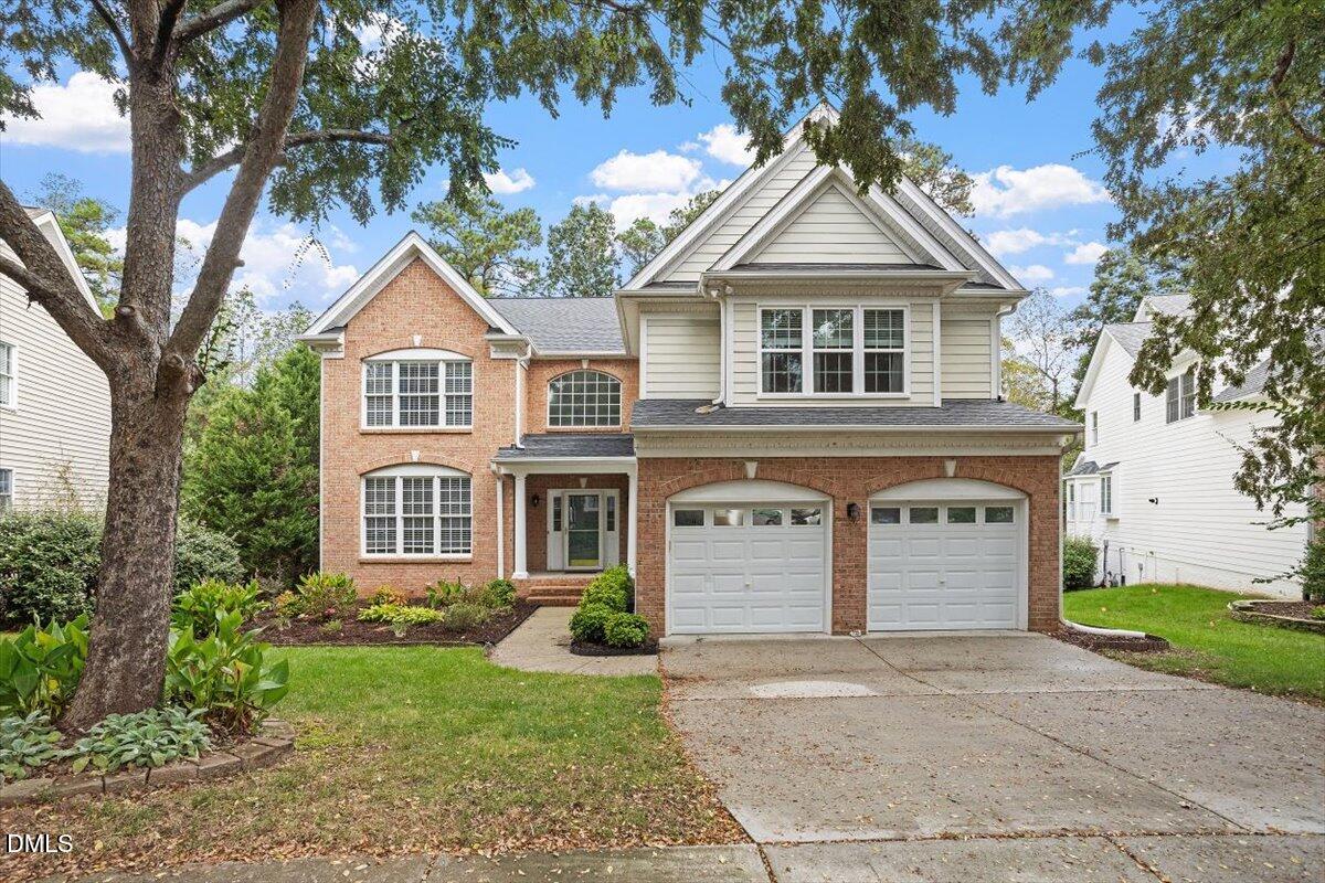 9208 Palm Bay Circle Raleigh, NC 27617 - Photo 3 of 54 a front view of a house with a yard and garage