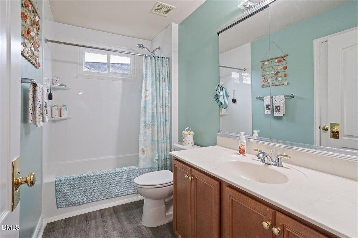 9208 Palm Bay Circle Raleigh, NC 27617 - Photo 40 of 54 a bathroom with a sink a toilet and shower