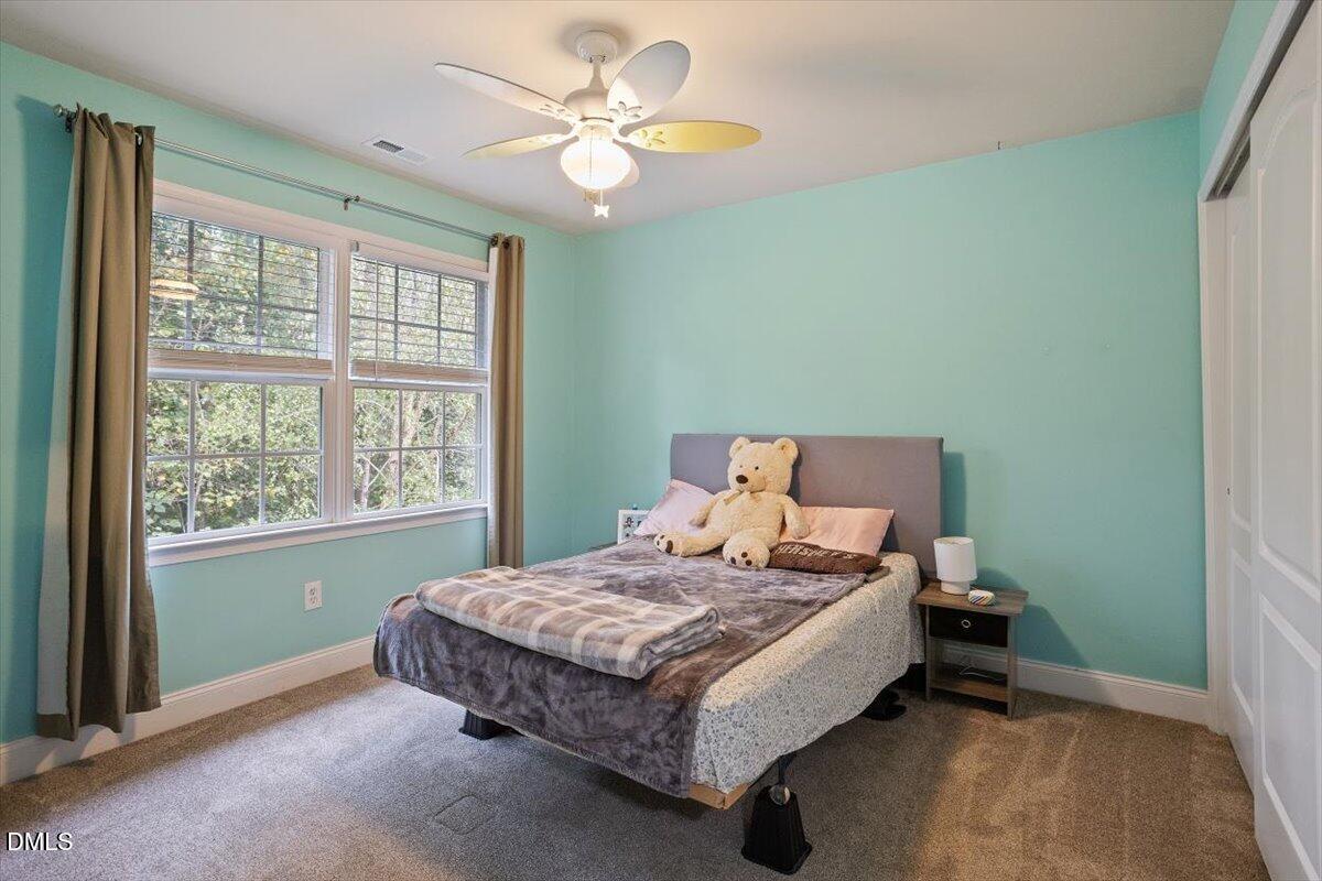 9208 Palm Bay Circle Raleigh, NC 27617 - Photo 41 of 54 a bedroom with a bed and a window