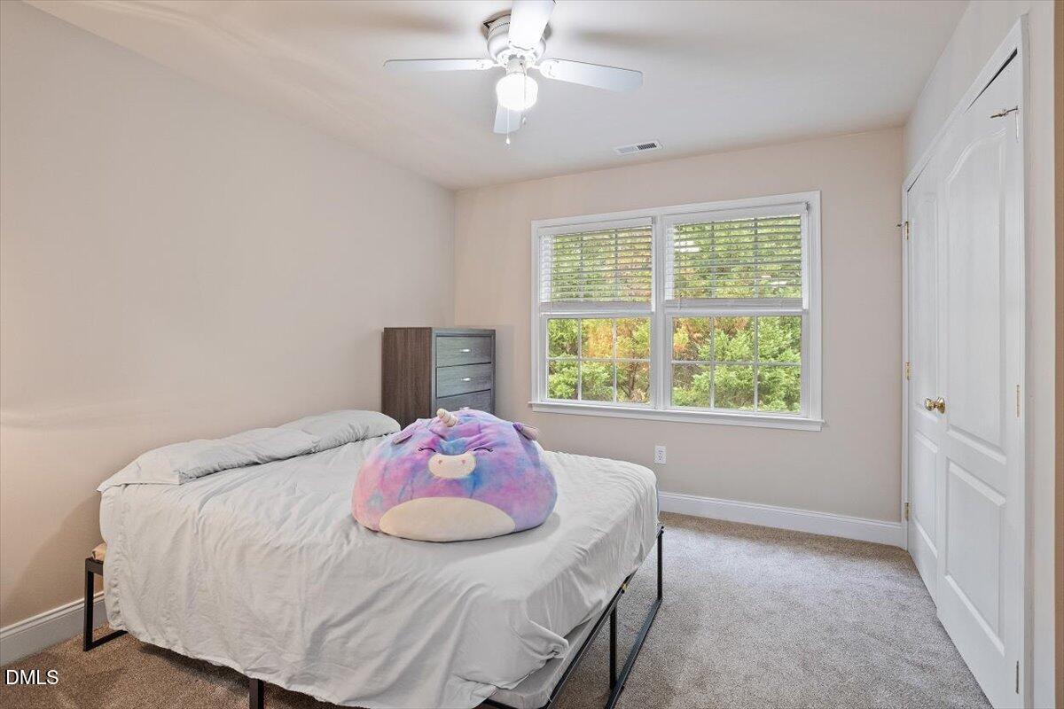 9208 Palm Bay Circle Raleigh, NC 27617 - Photo 43 of 54 a bedroom with a bed and a window