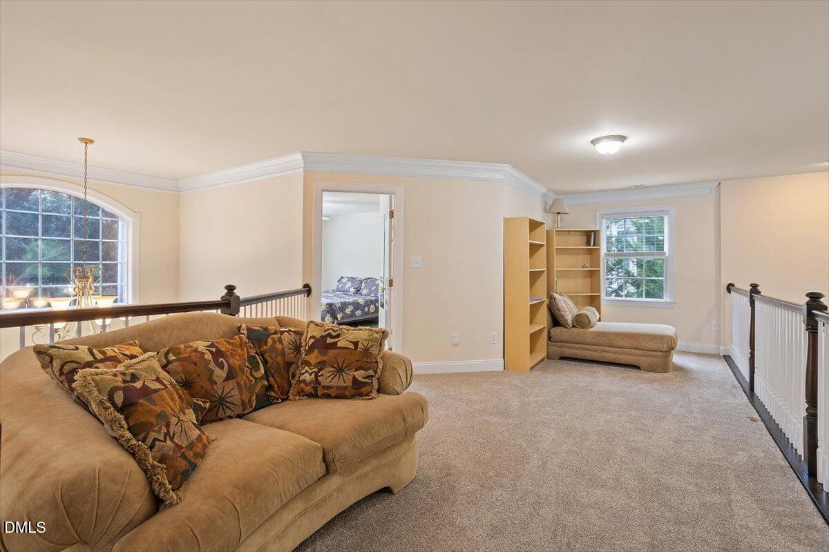 9208 Palm Bay Circle Raleigh, NC 27617 - Photo 44 of 54 a living room with furniture and a flat screen tv