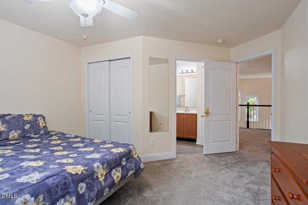 9208 Palm Bay Circle Raleigh, NC 27617 - Photo 48 of 54 a bedroom with a bed and a chandelier