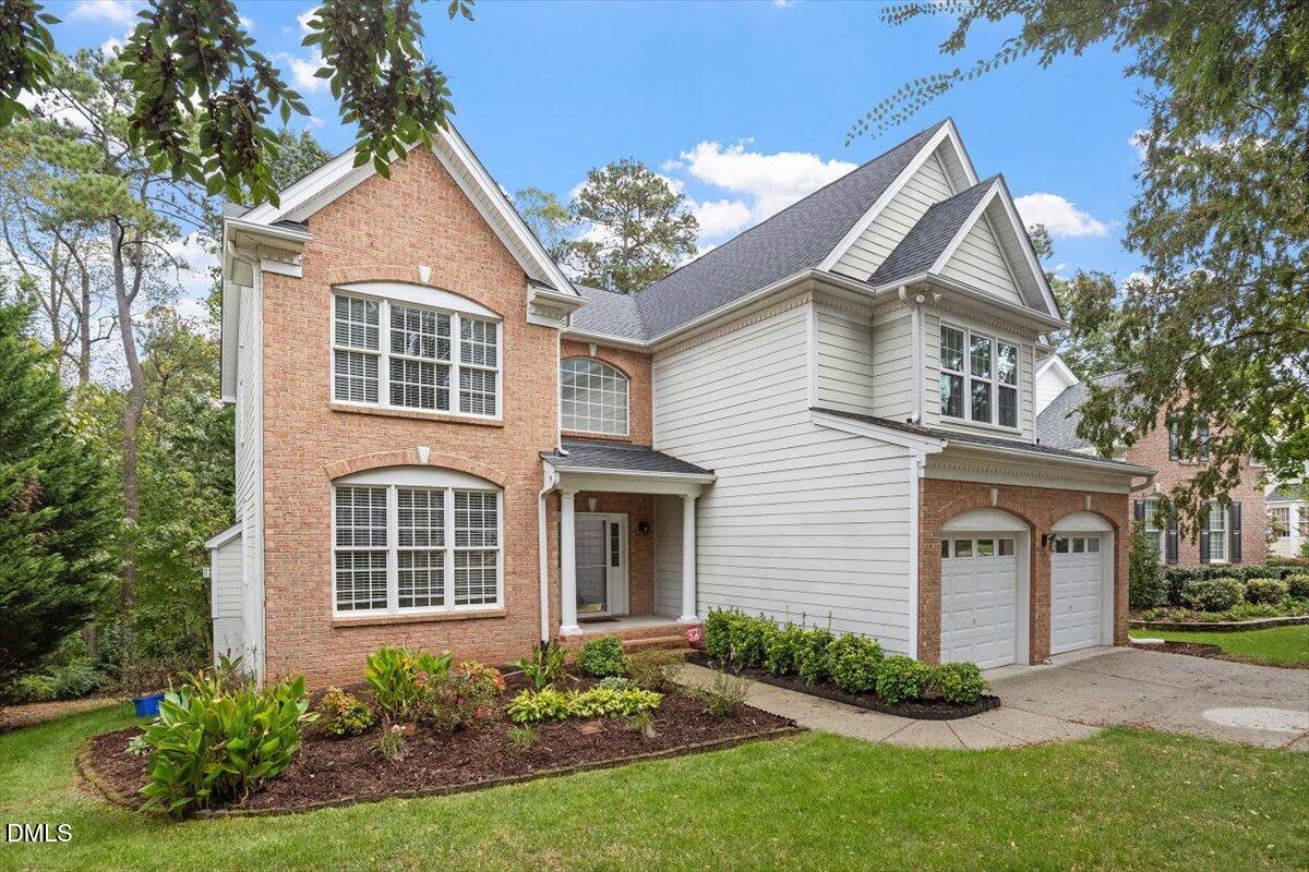 9208 Palm Bay Circle Raleigh, NC 27617 - Photo 4 of 54 a front view of a house with garden