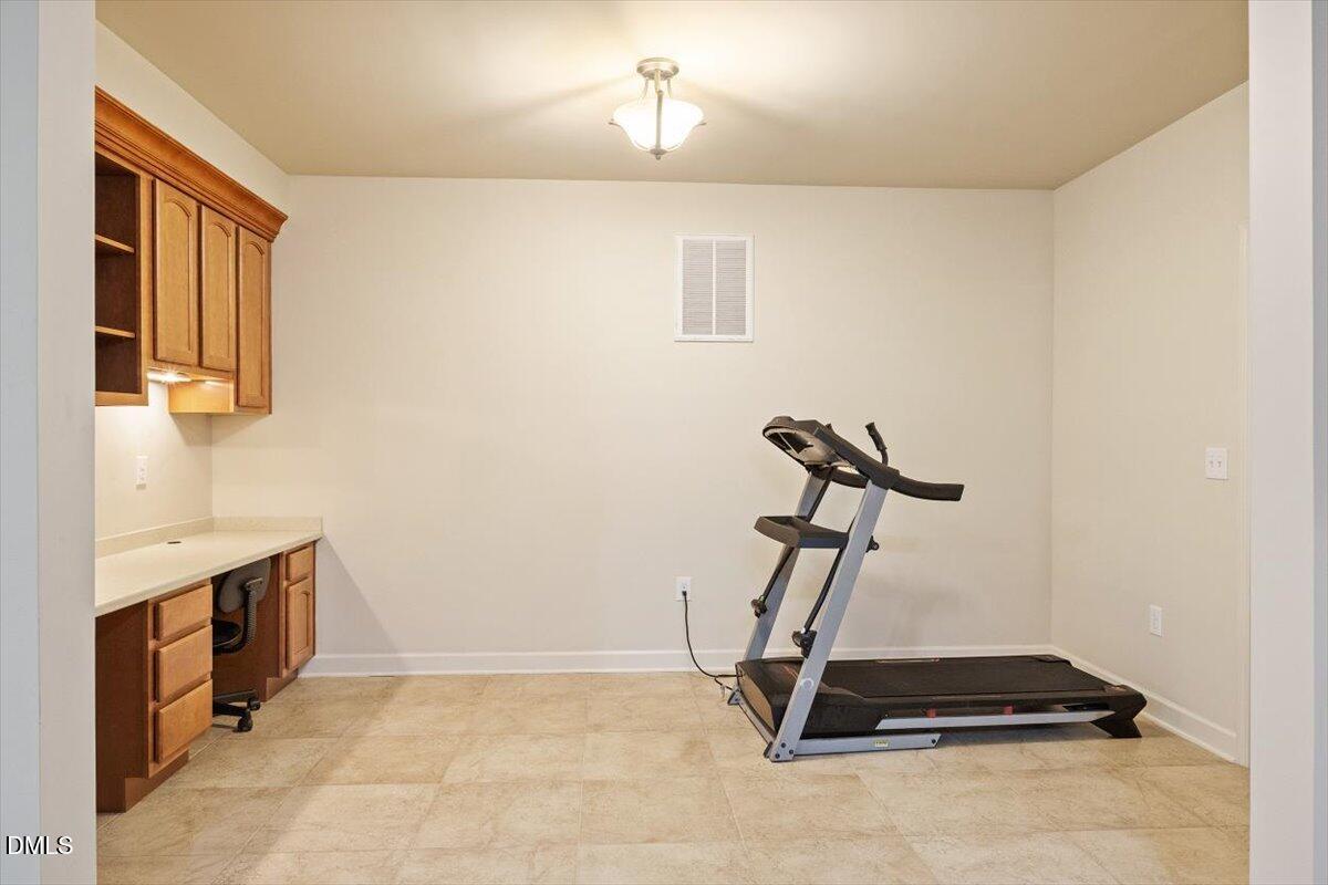 9208 Palm Bay Circle Raleigh, NC 27617 - Photo 53 of 54 a room with gym equipment and a view of living room